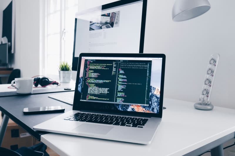 A workspace with technical drawings and a laptop